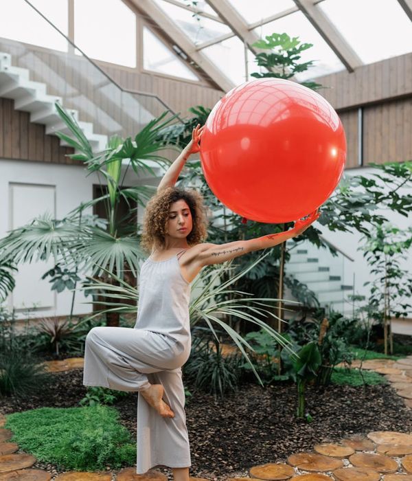 Woman holding a challenging balance pose in a calm setting.